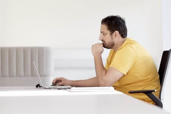 Student using laptop and headphones
